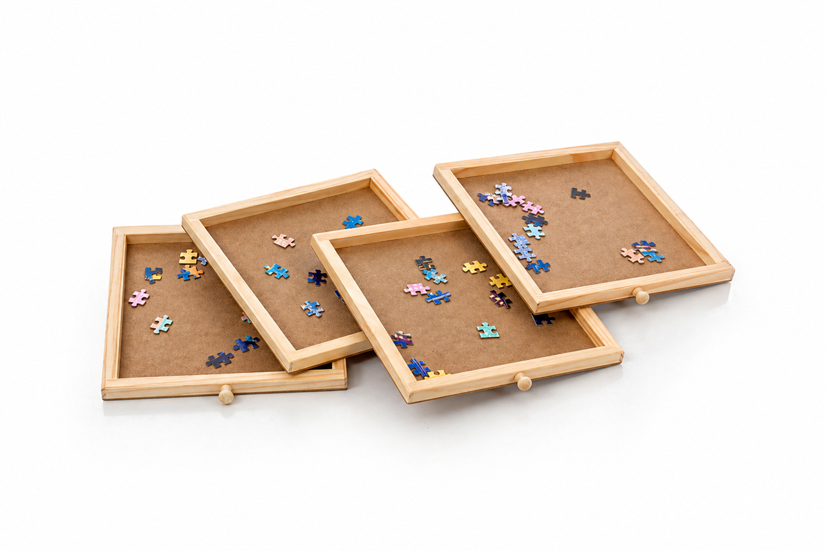 Four shallow wooden puzzle drawers organizing jigsaw pieces by color and pattern